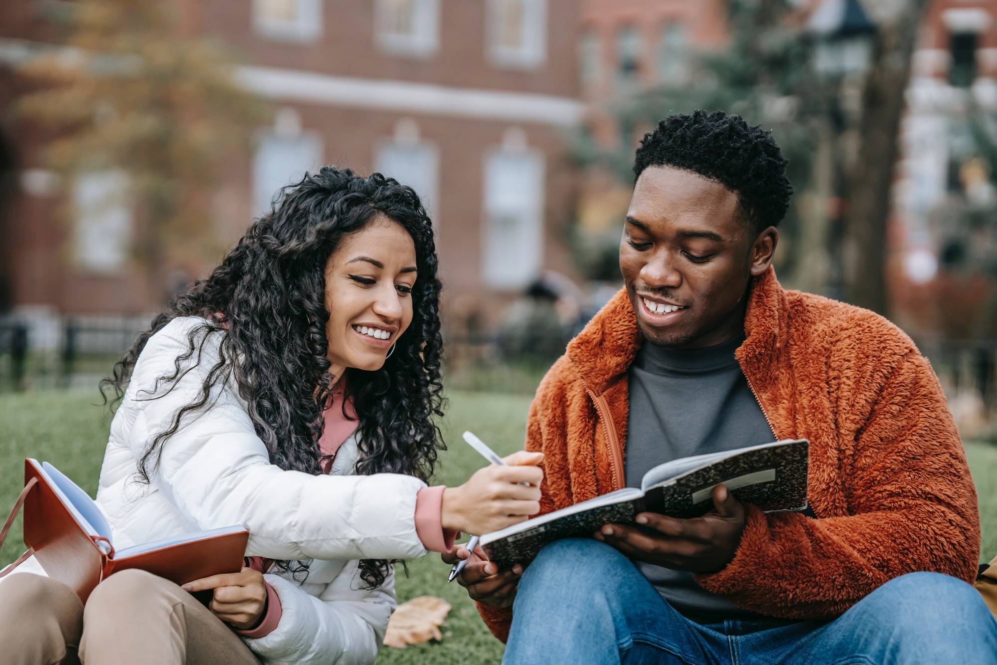 two students enjoying studying together outside